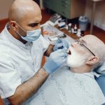 a old man is getting dental treatment