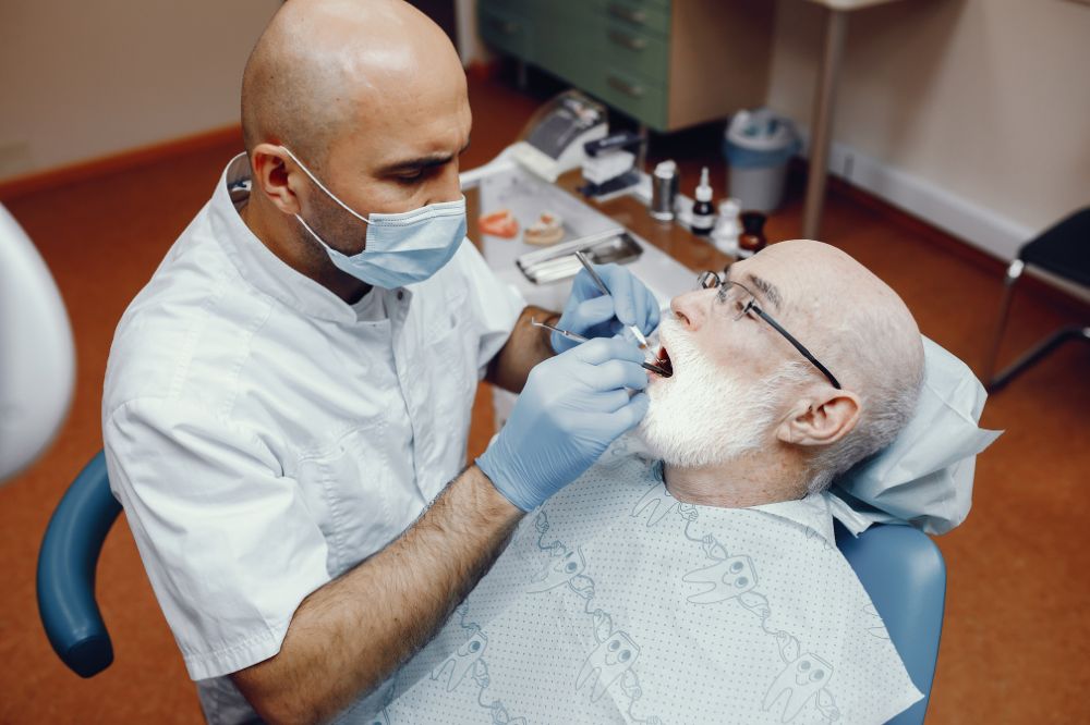 a old man is getting dental treatment
